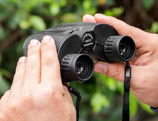 someone holding a binoculars